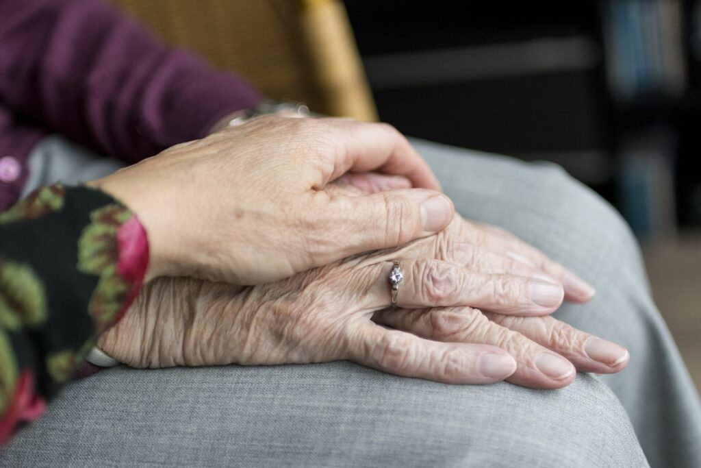 elderly holding hands